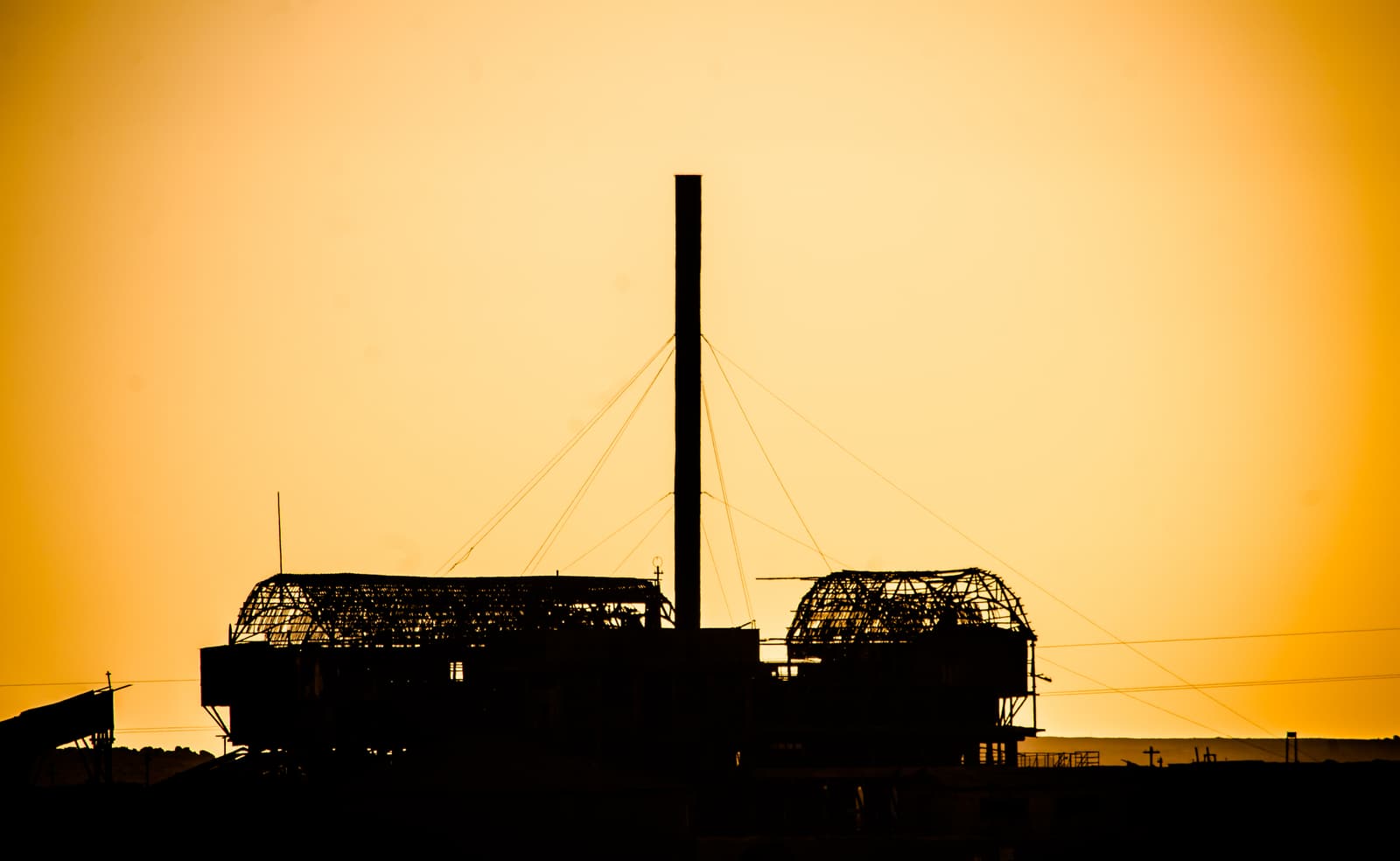 The silhouette of the abandoned Santa Laura saltpeter works at sunset
