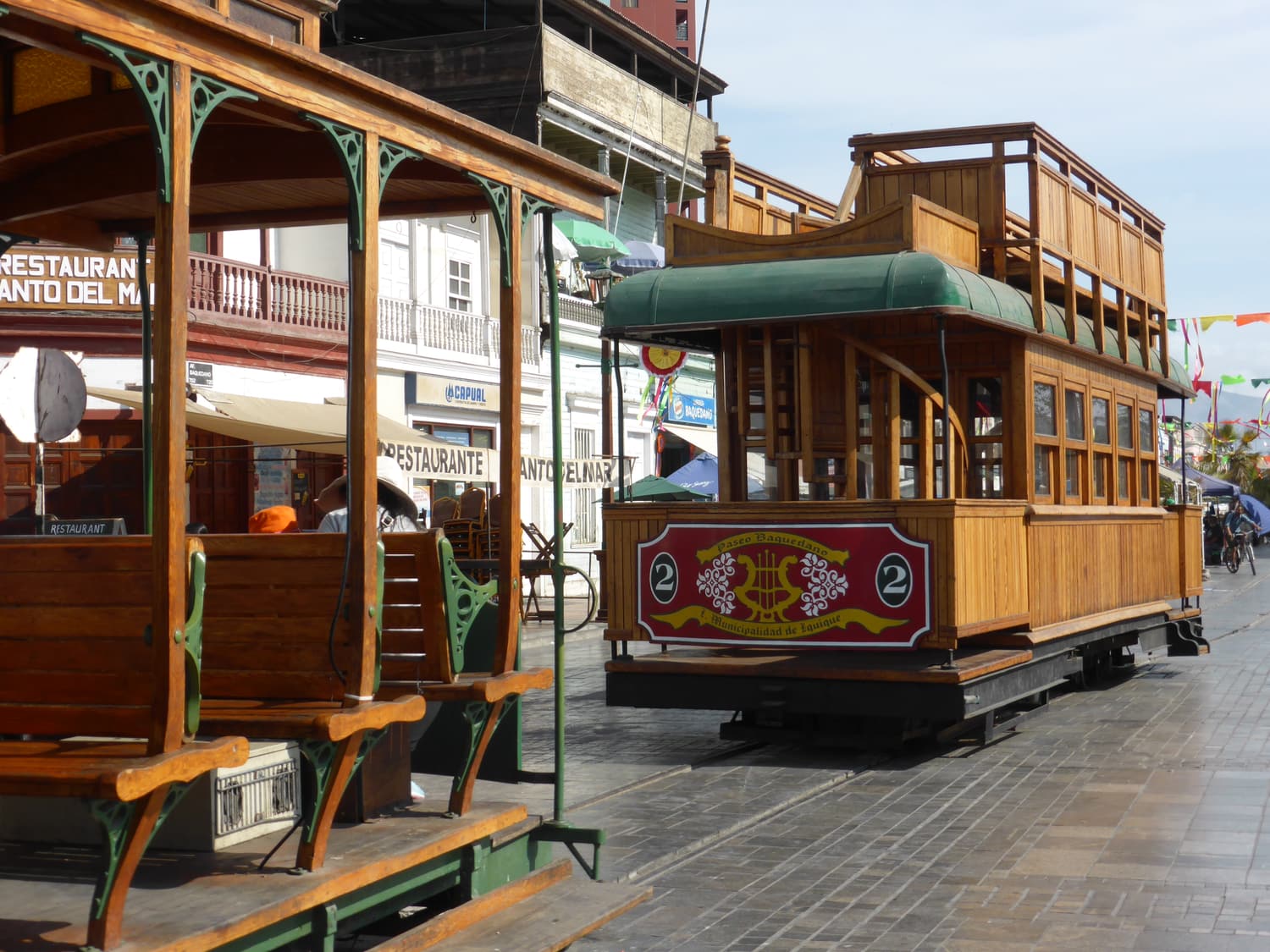 A heritage tram on the pedestrian Paseo Baquedano in Iquique, lined with wooden nitrate-era houses